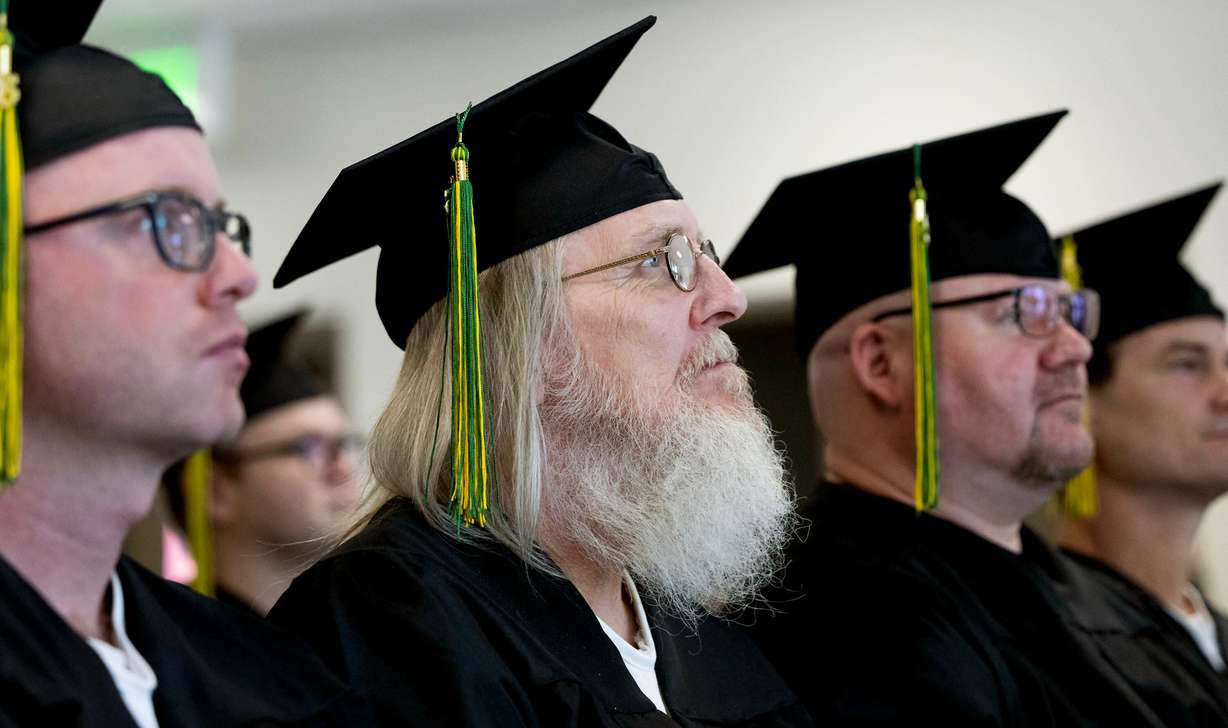Graduates of the Ensign College Prison Education Program stand during their graduation ceremony at the Utah State Correctional Facility in Salt Lake City on Wednesday. The ceremony was the first held off-campus in the school's history.
