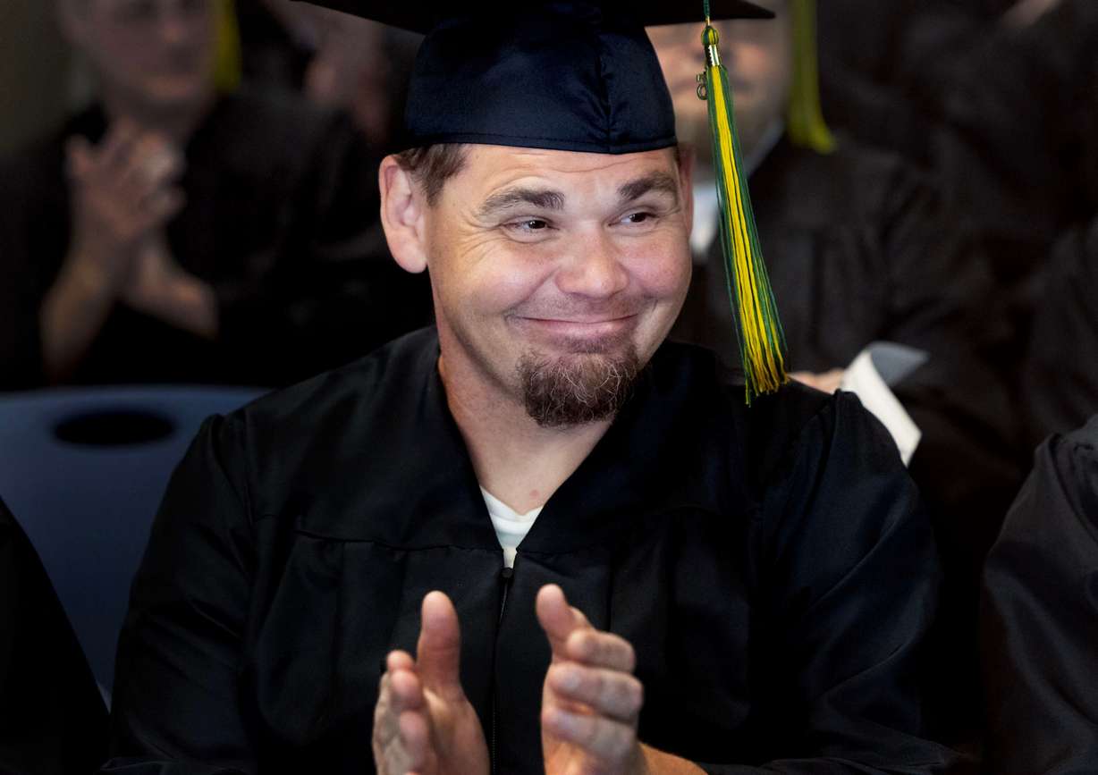 Stephen applauds during the Ensign College Prison Education Program graduation ceremony at the Utah State Correctional Facility in Salt Lake City on Wednesday. The ceremony was the first held off-campus in school history.