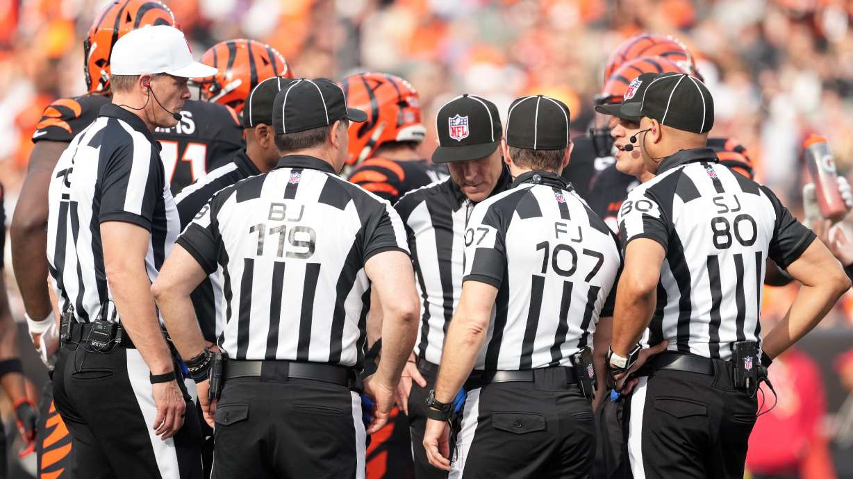 FILE - Referee Clay Martin (19), far left, talks with the officiating crew during an NFL football game between the Arizona Cardinals and the Cincinnati Bengals, Sunday, Dec. 28, 2025, in Cincinnati.