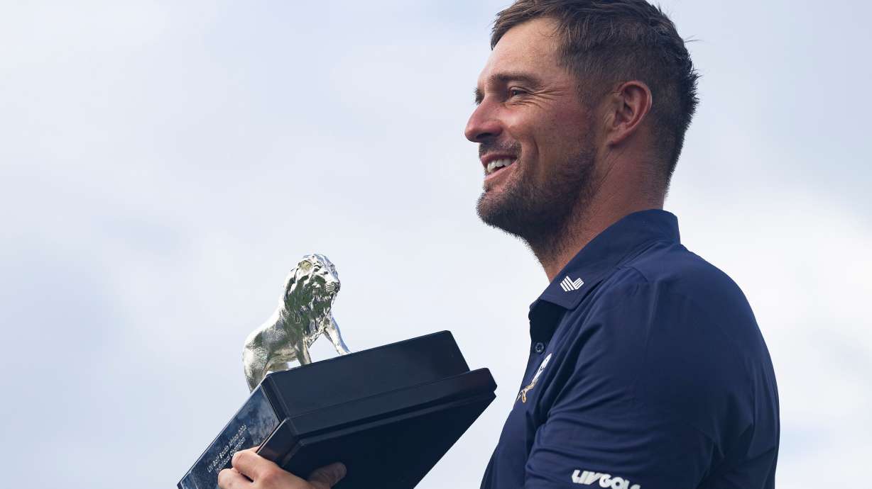 First-place individual champion, captain Bryson DeChambeau, of Crushers GC, poses for a photo with the trophy after the final round of LIV Golf South Africa at The Club at Steyn City, Sunday, March 22, 2026, in Midrand, South Africa.