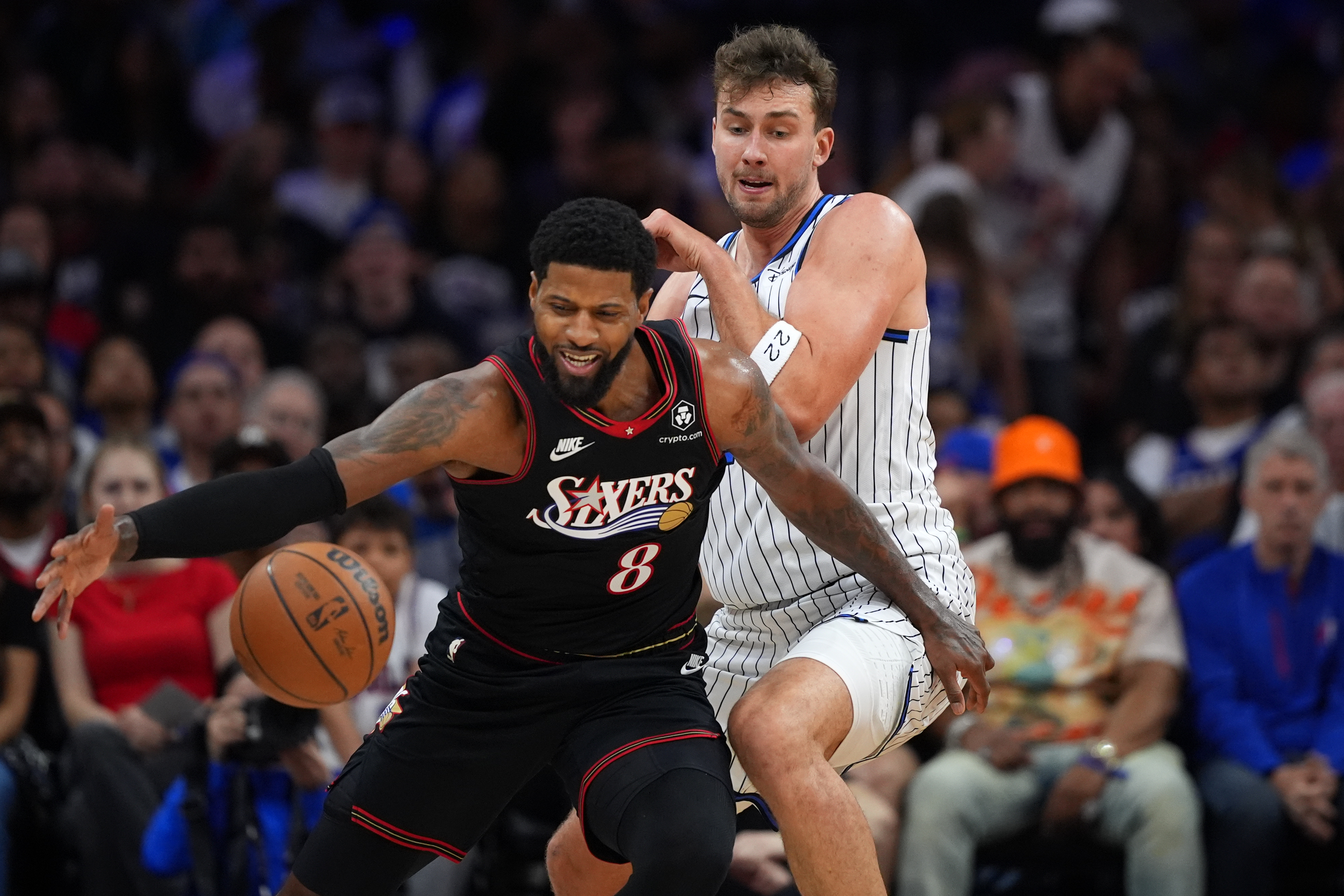 Philadelphia 76ers' Paul George, left, tries to get past Orlando Magic's Franz Wagner during the first half of an NBA play-in tournament basketball game Wednesday, April 15, 2026, in Philadelphia.