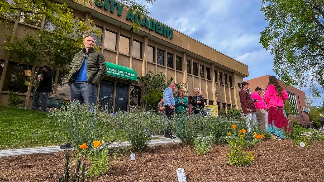 People explore the "Go Native! Community Garden" outside of City Academy in Salt Lake City on Wednesday. The garden, designed by students, offers residents examples for starting their own native plant gardens.