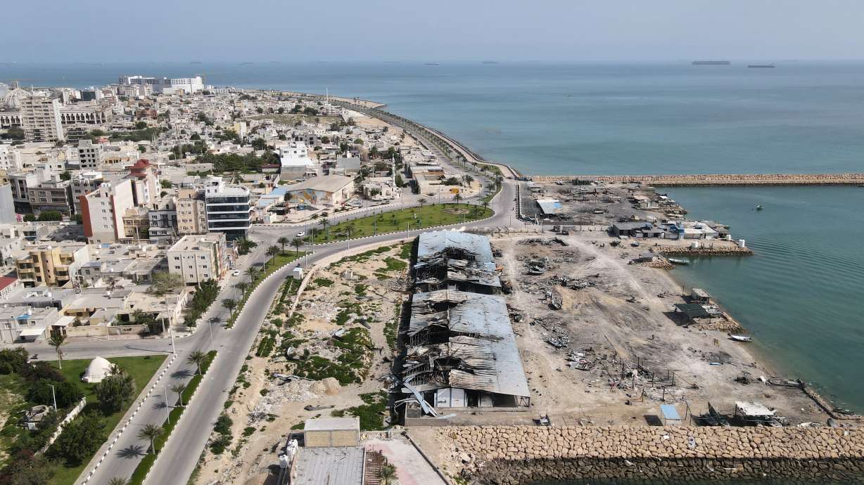 Backdropped by ships in the Strait of Hormuz, damage, according to local witnesses caused by several recent airstrikes during the U.S.-Israel military campaign, is seen on a fishing pier in the port of Qeshm island, Iran, Monday. President Donald Trump says Israel and Lebanon have agreed to a 10-day ceasefire.