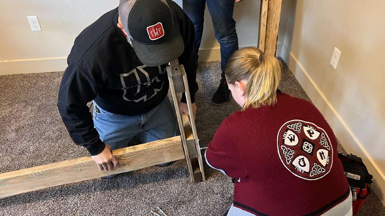 A student at West Point Junior High works with a member of the nonprofit Sleep in Heavenly Peace to assemble a bed frame in an undated photo. Students, volunteers and others will build 40 beds during an event on Saturday.