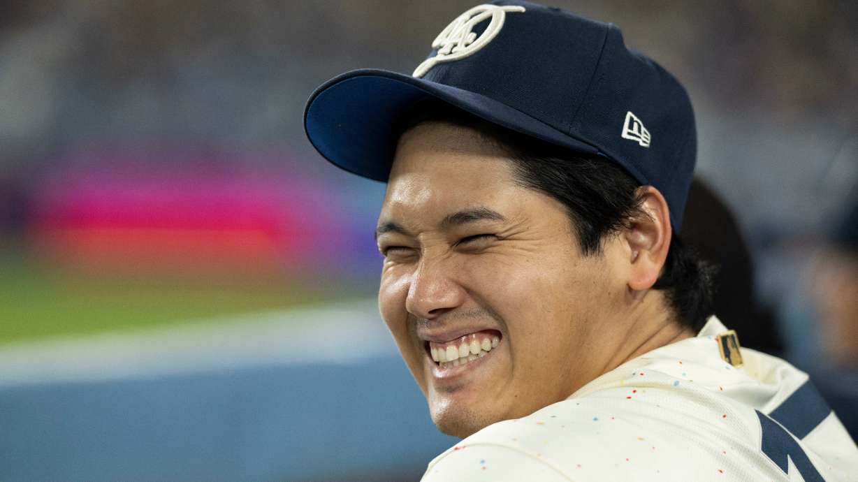 Los Angeles Dodgers' Shohei Ohtani smiles during the ninth inning of a baseball game against the Texas Rangers in Los Angeles, Saturday, April 11, 2026.