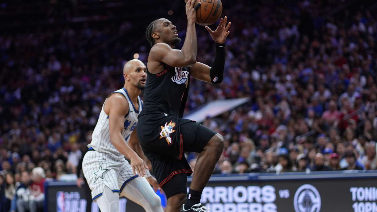 Philadelphia 76ers' Tyrese Maxey, right, goes up for a shot against Orlando Magic's Jalen Suggs during the second half of an NBA play-in tournament basketball game Wednesday, April 15, 2026, in Philadelphia.