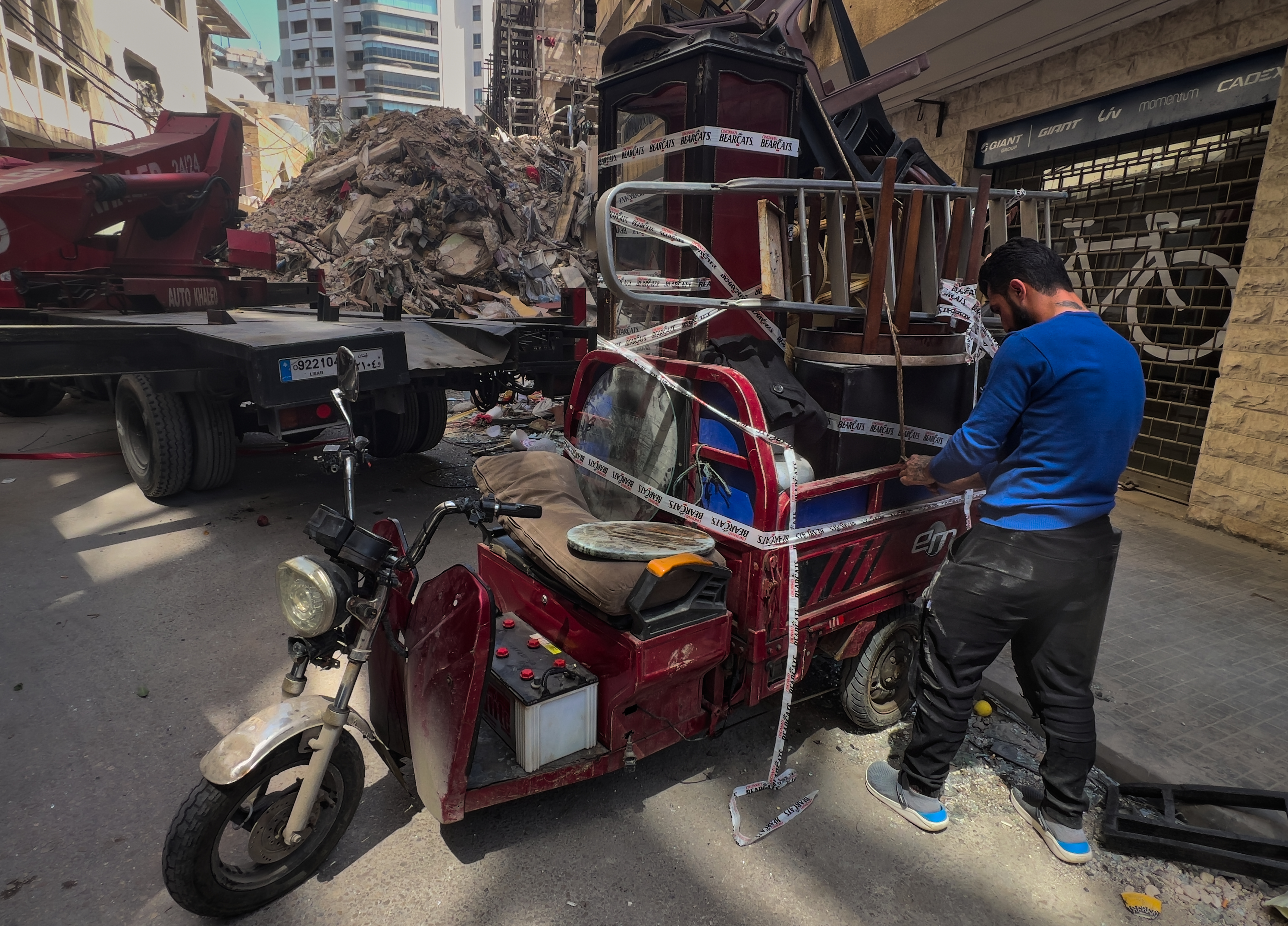 A worker arranges furniture from an apartment of a destroyed building that was hit a week ago in an Israeli airstrike in central Beirut, Lebanon, Thursday.