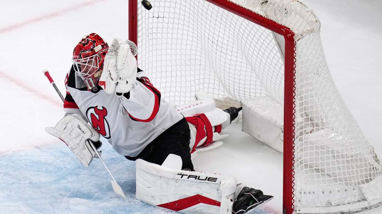New Jersey Devils goaltender Nico Daws (50) fails to make a save on a shot by Boston Bruins center Mark Kastelic during the first period of a hockey game, Tuesday, April 14, 2026, in Boston.