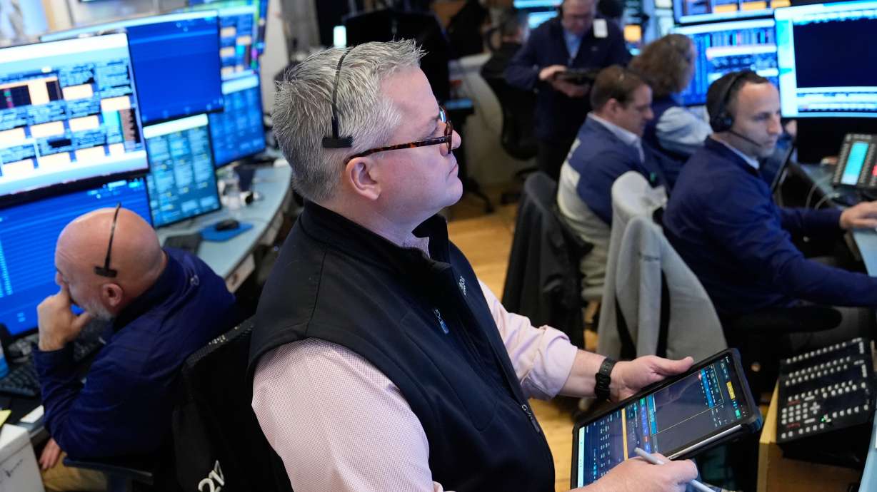 People work on the floor at the New York Stock Exchange in New York, Monday. Oil prices dropped and the Dow soared after Iran reopened the Strait of Hormuz.