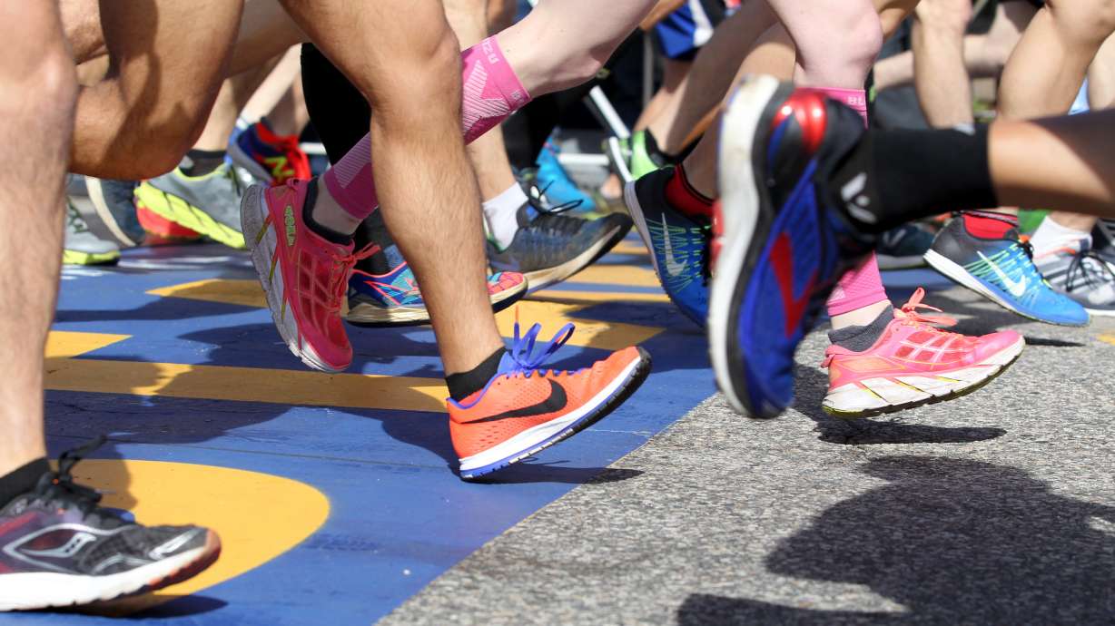 FILE - A colorful collection of shoes cross the starting line at the start of the 2017 Boston Marathon in Hopkinton, Mass., Monday, April 17, 2017.