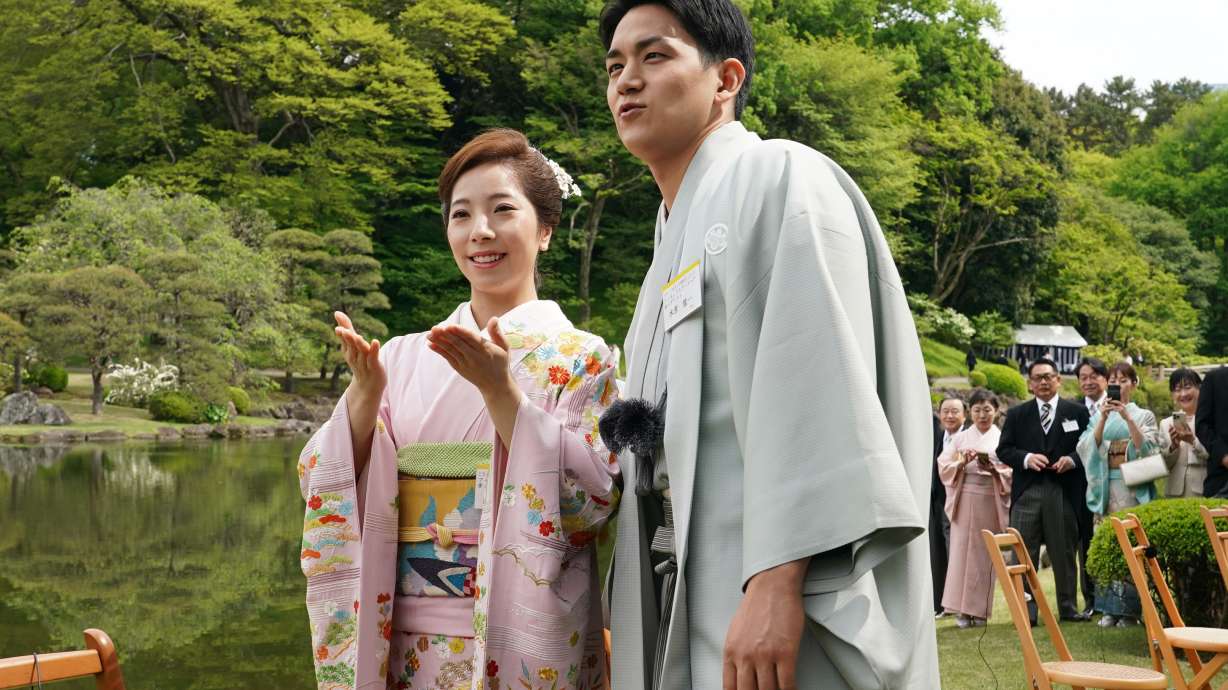 Japanese Olympic figure skating pairs champions Riku Miura, left, and Ryuichi Kihara attend a spring garden party hosted by Japan's Emperor Naruhito and Empress Masako at the Akasaka Palace's imperial garden in Tokyo, Friday, April 17, 2026.