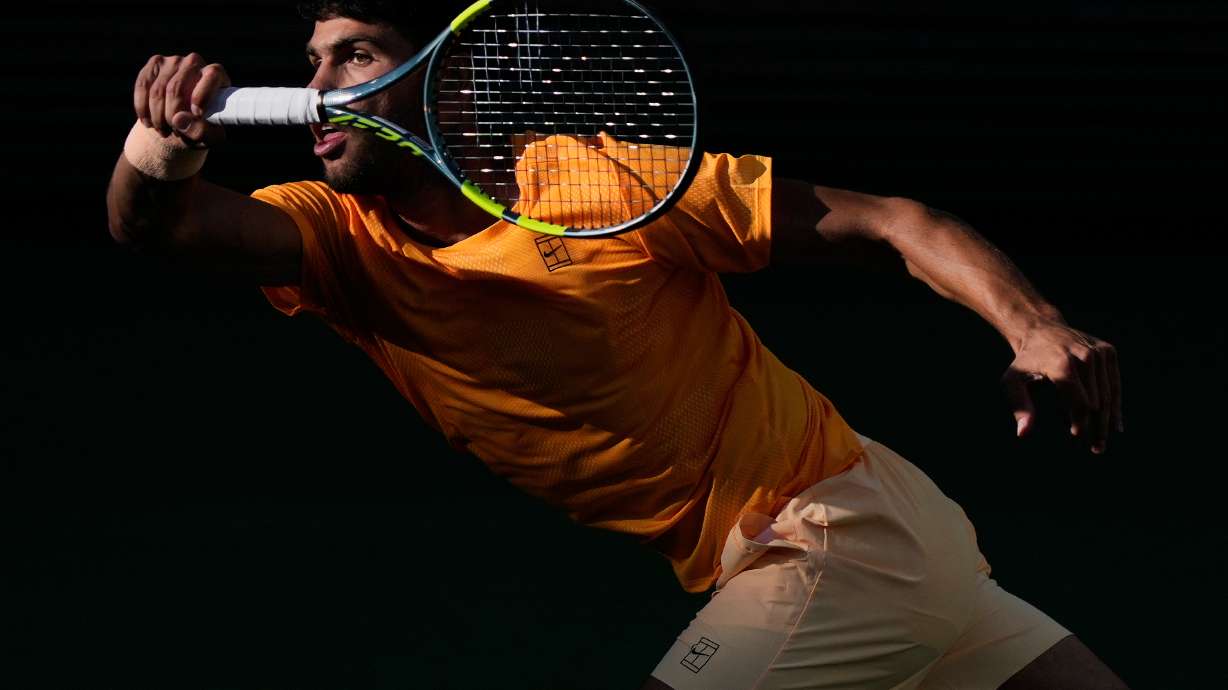 Carlos Alcaraz, of Spain, returns a shot against Daniil Medvedev, of Russia, during a semifinal match at the BNP Paribas Open tennis tournament, Saturday, March 14, 2026, in Indian Wells, Calif.