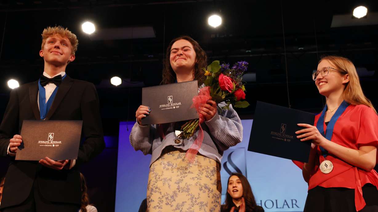 Sarah Pace attempts to hold back tears as she is honored as the Sterling Scholar in science, alongside runners-up Rockland Stout and Senya Walker at the Bountiful Regional Center in Bountiful, Thursday.