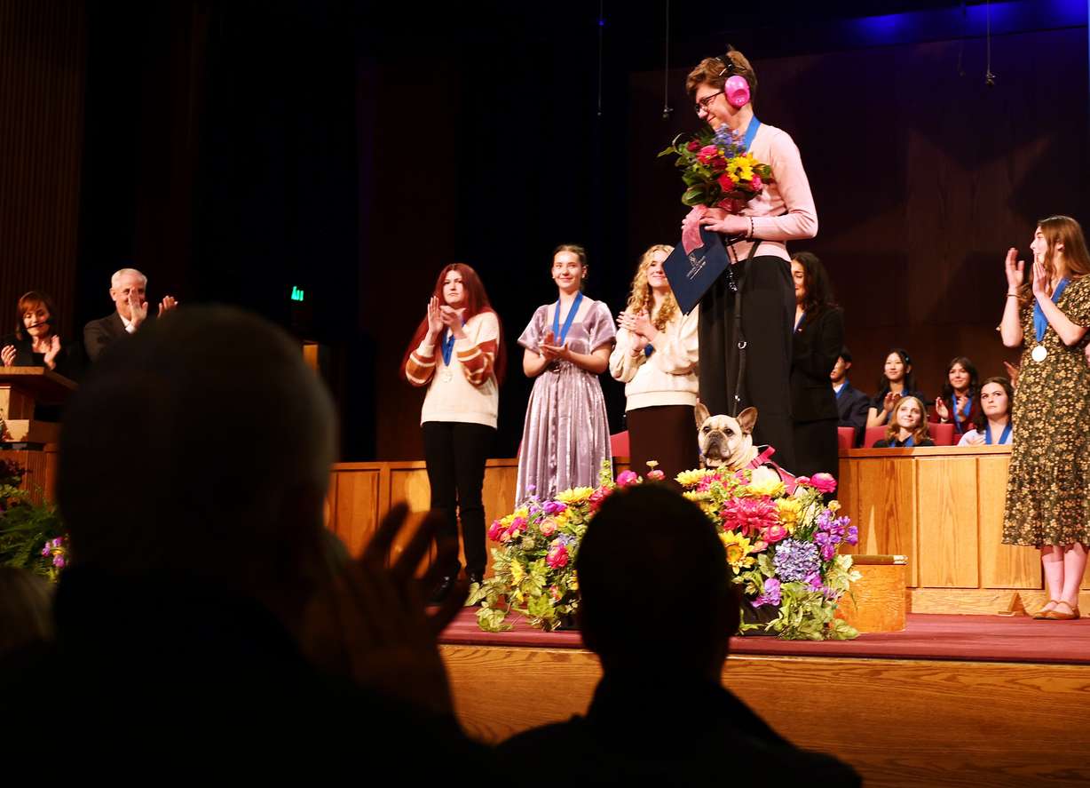 Emma Lewis of Beehive Academy is applauded as the Sterling Scholar in visual arts during the Sterling Scholar Awards presentation at the Bountiful Regional Center in Bountiful, Thursday. Lewis is autistic and was accompanied by a service dog.