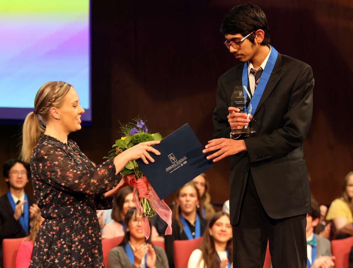Om Sanghvi of Hillcrest High is honored with the Philo T. Farnsworth Governor’s Award and receives his certificate from Kristen Kingsley during the Sterling Scholar Awards presentation at the Bountiful Regional Center in Bountiful, Thursday.