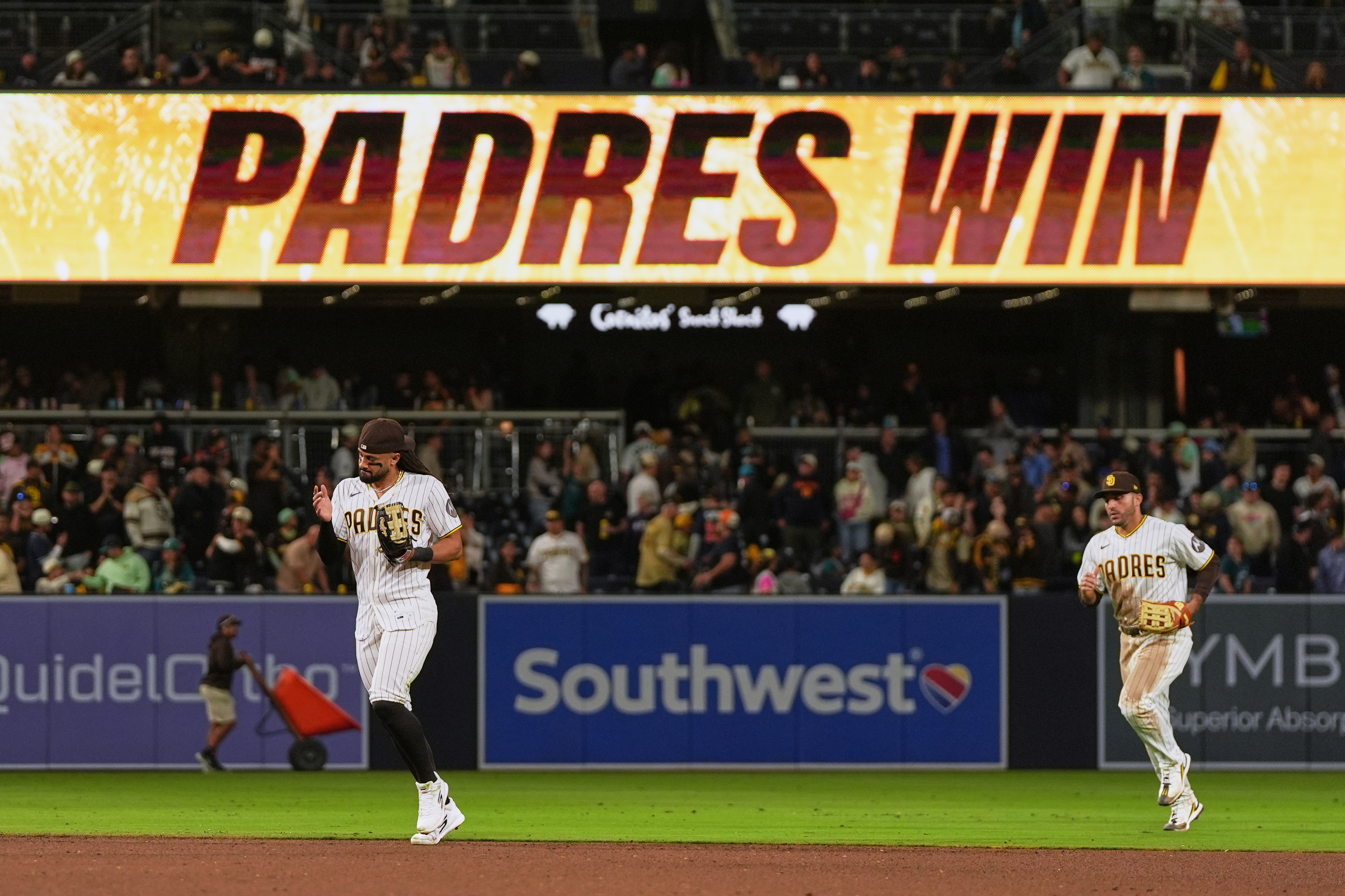 San Diego Padres right fielder Fernando Tatis Jr., left, and left fielder Ramón Laureano celebrate after the Padres defeated the Seattle Mariners 5-2 in a baseball game Thursday, April 16, 2026, in San Diego. 