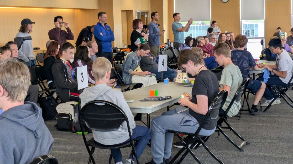 People compete in a Rubik's cube competition to help raise money for Giant Steps Autism Preschool on April 11.