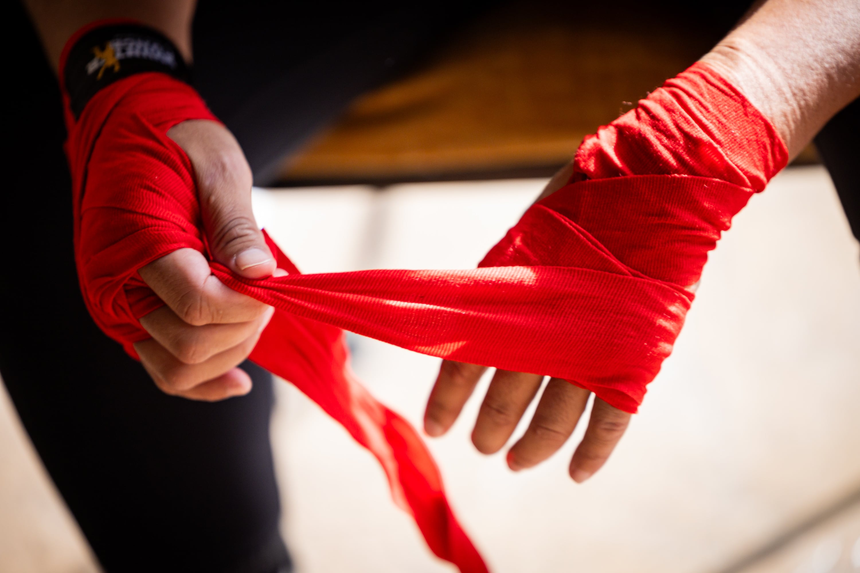 World boxing champion Lani Daniels, a member of The Church of Jesus Christ of Latter-day Saints, unwraps her hands after training at her friend Caroline Kreutzkamp’s home in Orem on April 10. Daniels’ long arc in the sport is connected to her family.