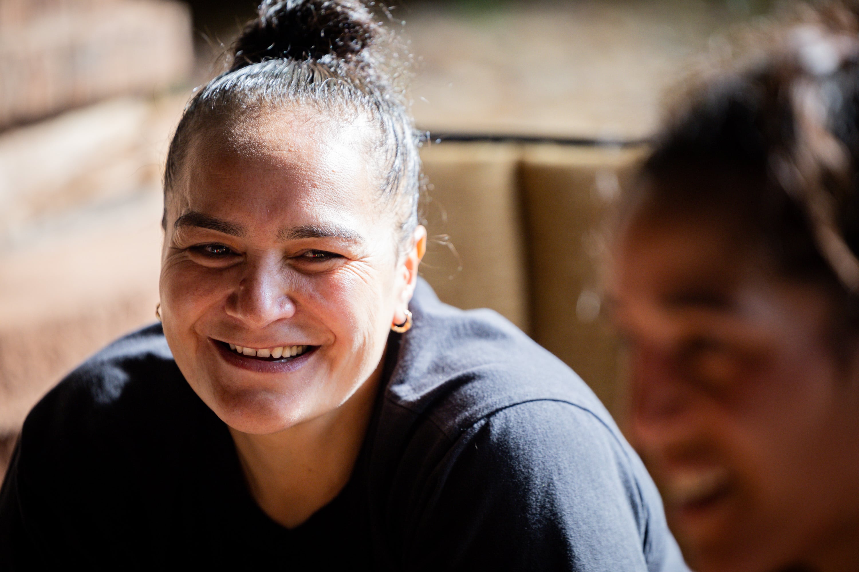 Caroline Daniels smiles at her sister, world boxing champion, Lani Daniels, a member of The Church of Jesus Christ of Latter-day Saints, after training with her at their friend Caroline Kreutzkamp’s home in Orem on April 10. Lani Daniels said she is grateful to have the Kreutzkamps supporting her and her family.