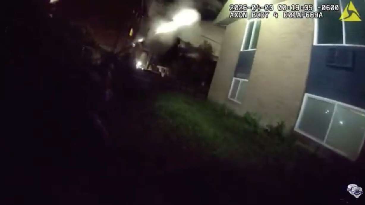 A Salt Lake police officer fires a gun toward an apartment window during a search warrant that was executed in Salt Lake City on April 3. A 37-year-old man was injured, and the shooting remains under investigation.