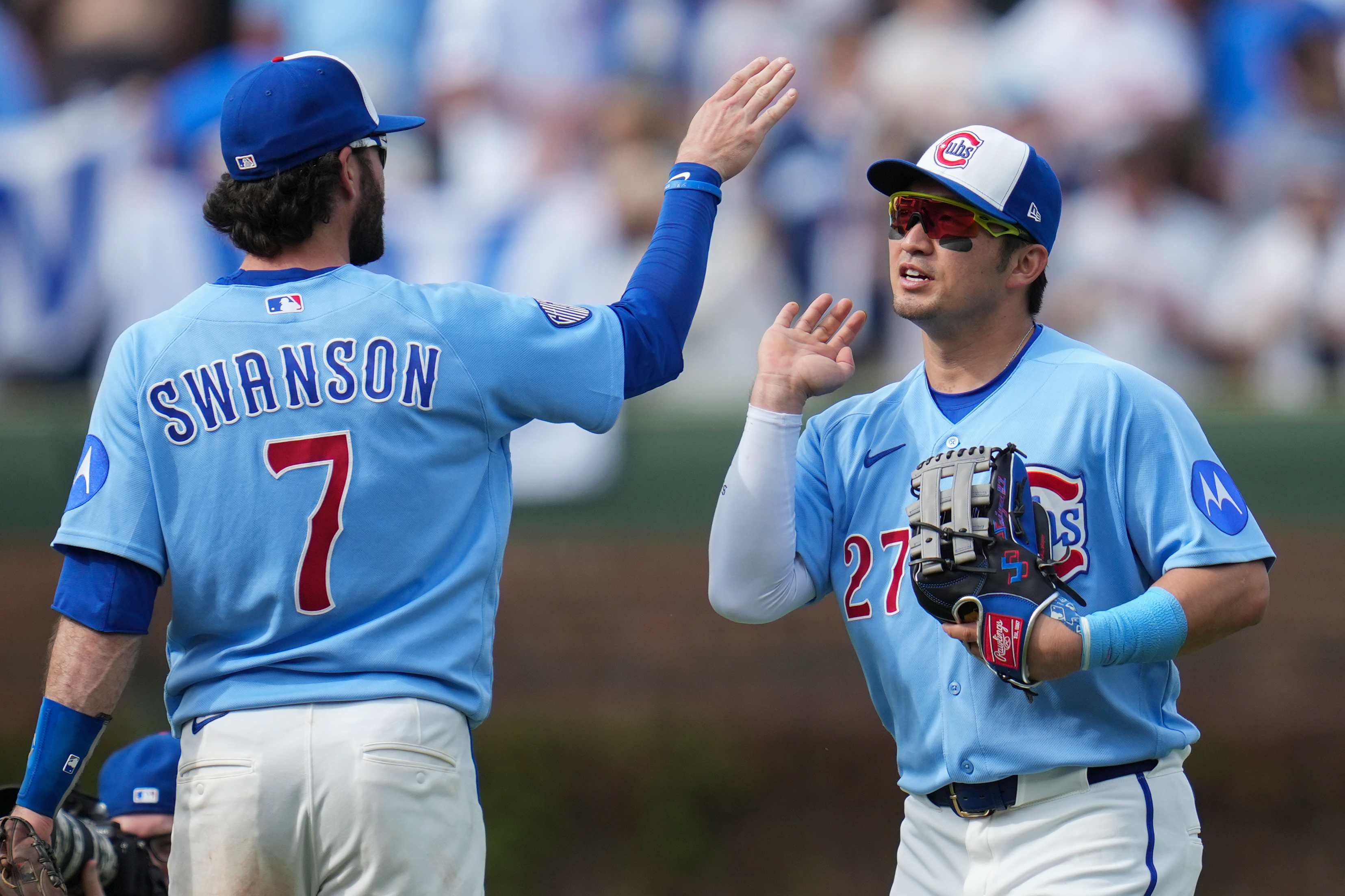 Chicago Cubs' Dansby Swanson (7) and Seiya Suzuki (27) celebrate their team's win over the New York Mets in a baseball game Friday, April 17, 2026, in Chicago. 