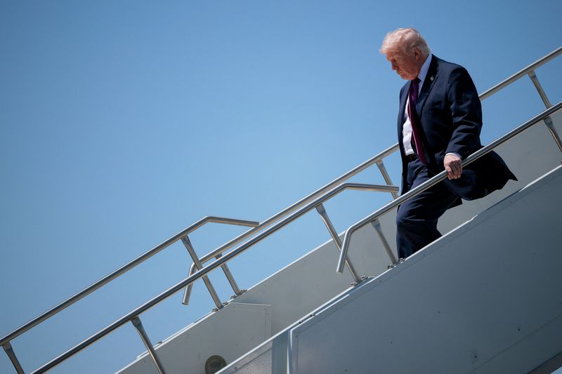 President Donald Trump disembarks Air Force One, as he arrives at Phoenix Sky Harbor International Airport in Phoenix, Ariz., Friday. Trump said he expected a deal to end the Iran war would come "soon."