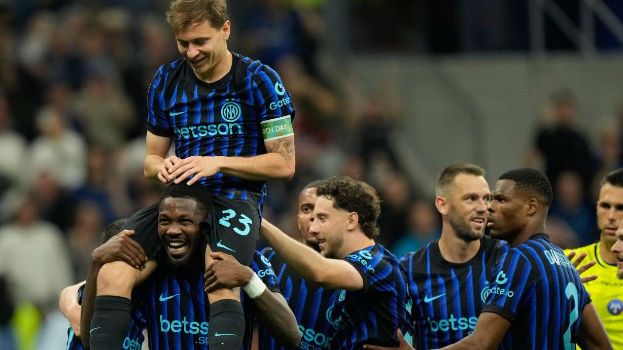 Inter Milan's Nicolo Barella, on Marcus Thuram shoulders, celebrates after scoring his side's 2nd goal during the Serie A soccer match between Inter Milan and Cagliari in Milan, Italy, Friday, April 17, 2026.
