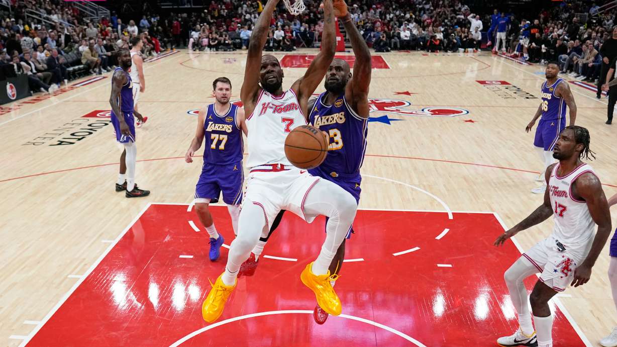 Houston Rockets' Kevin Durant (7) dunks the ball as Los Angeles Lakers' LeBron James (23) defends during the second half of an NBA basketball game Wednesday, March 18, 2026, in Houston.