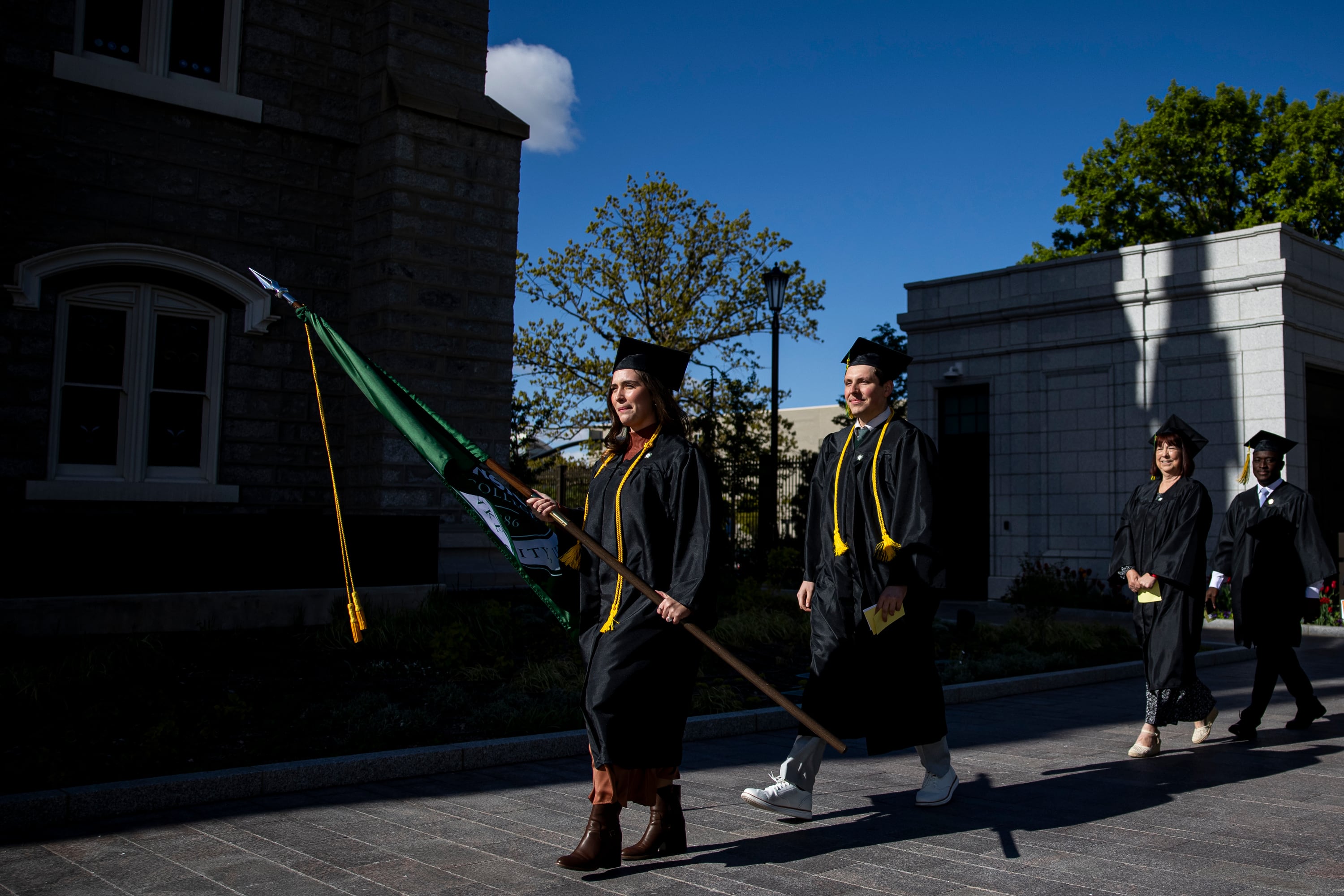 Barbara Alves, a Bachelor of Applied Science graduate in business management, from Sao Paulo, Brazil, holds the Ensign College flag as graduating students process into the Salt Lake Tabernacle on Temple Square for the 139th Ensign College commencement exercises in Salt Lake City on Friday. Alves told graduates the future is as bright as their faith in Christ.