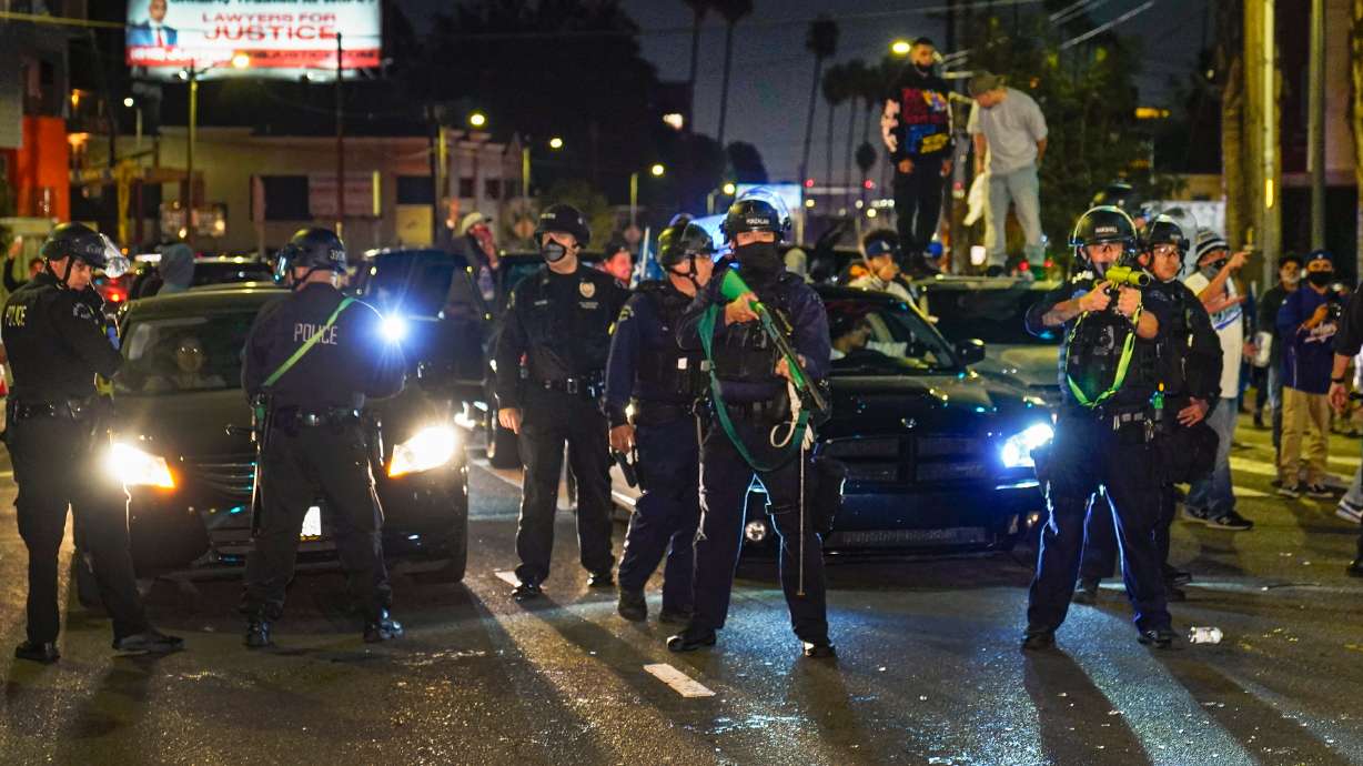 FILE - Members of the Los Angeles Police order fans to disperse on Sunset Boulevard in Los Angeles, Oct. 27, 2020, after the Los Angeles Dodgers won the baseball World Series against the Tampa Bay Rays.