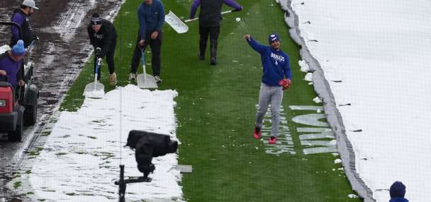A mid-April snowstorm coats Coors Field as Dodgers-Rockies series gets off to frosty start