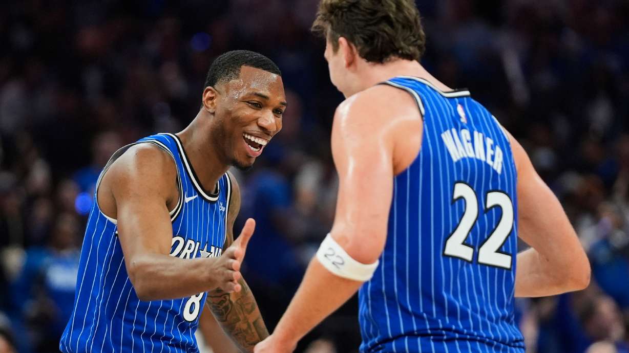 Orlando Magic forward Jamal Cain, left, celebrates a big play against the Charlotte Hornets with forward Franz Wagner (22) during the second half of an NBA play-in tournament basketball game, Friday, April 17, 2026, in Orlando, Fla.