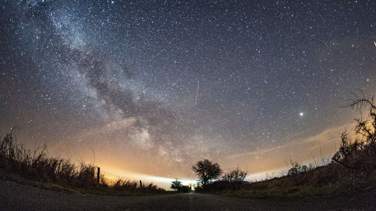 The milky way and traces of meteors illuminate the sky over Burg on the Baltic Sea island of Fehmarn, northern Germany, April 20, 2018.