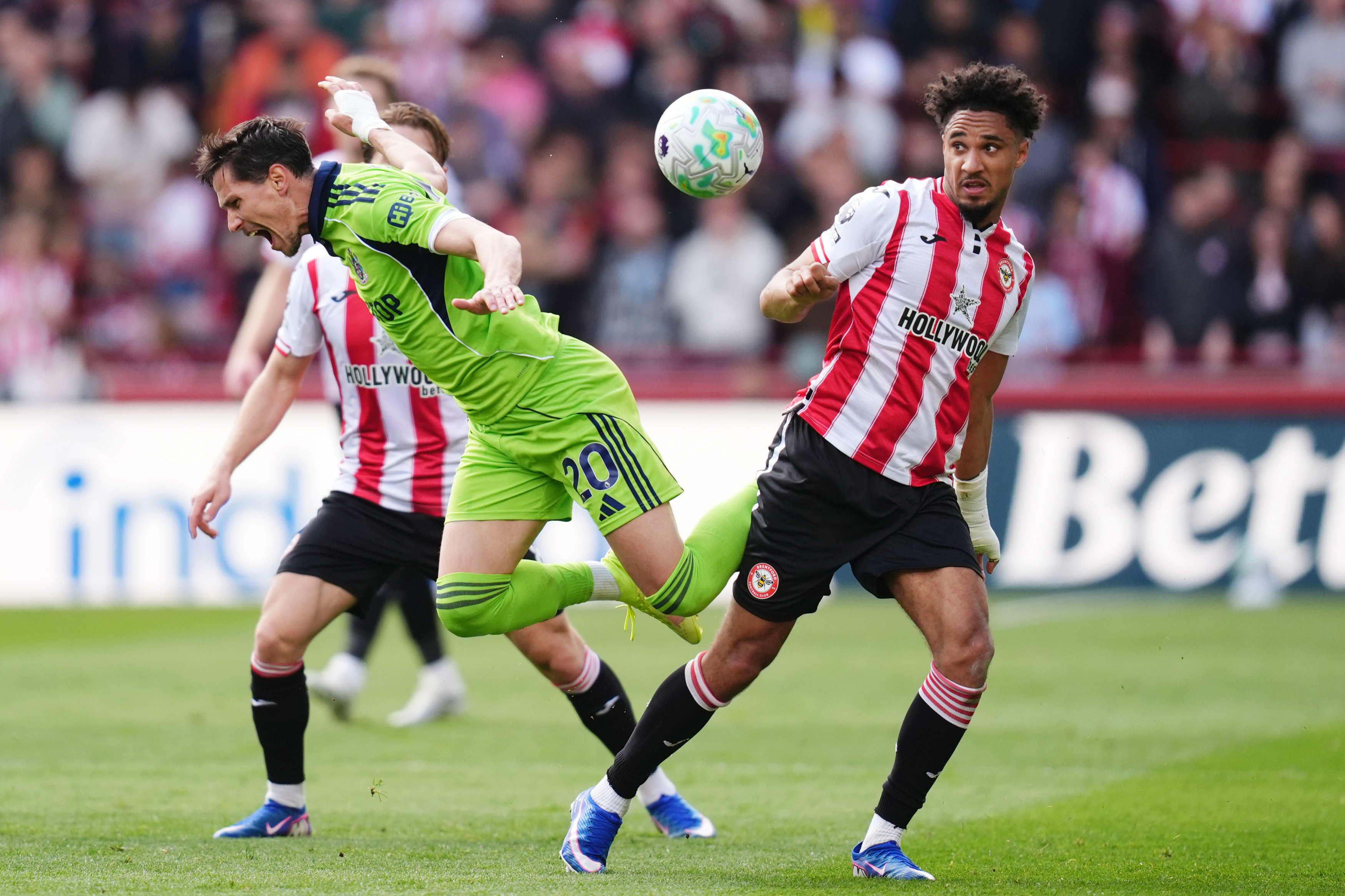 Fulham's Sasa Lukic, left, and Brentford's Kevin Schade battle for the ball during the English Premier League soccer match between Brentford and Fulham in Brentford, England, Saturday April 18, 2026. 