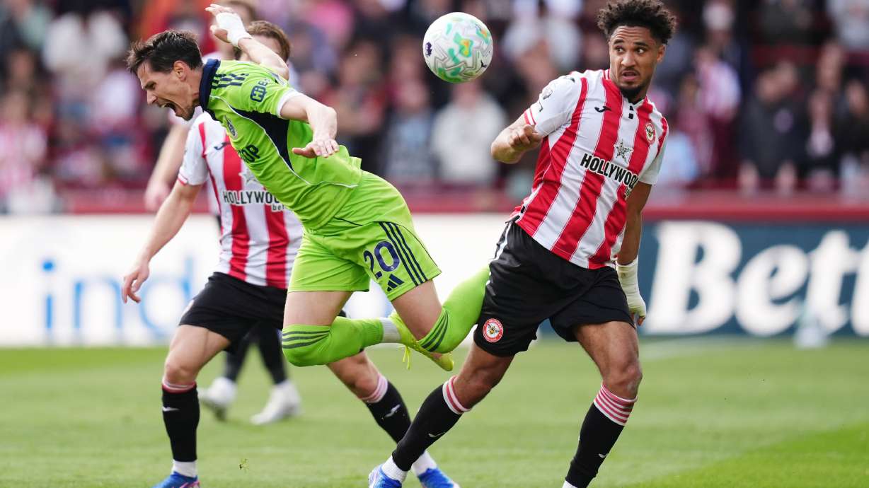 Fulham's Sasa Lukic, left, and Brentford's Kevin Schade battle for the ball during the English Premier League soccer match between Brentford and Fulham in Brentford, England, Saturday April 18, 2026.