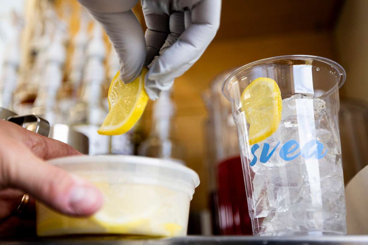 Alfred Kilis, co-owner of SVEA Scandinavian Kafé on Wheels, prepares a lemon elderflower iced refresher in his food truck in Eagle Mountain on April 10.