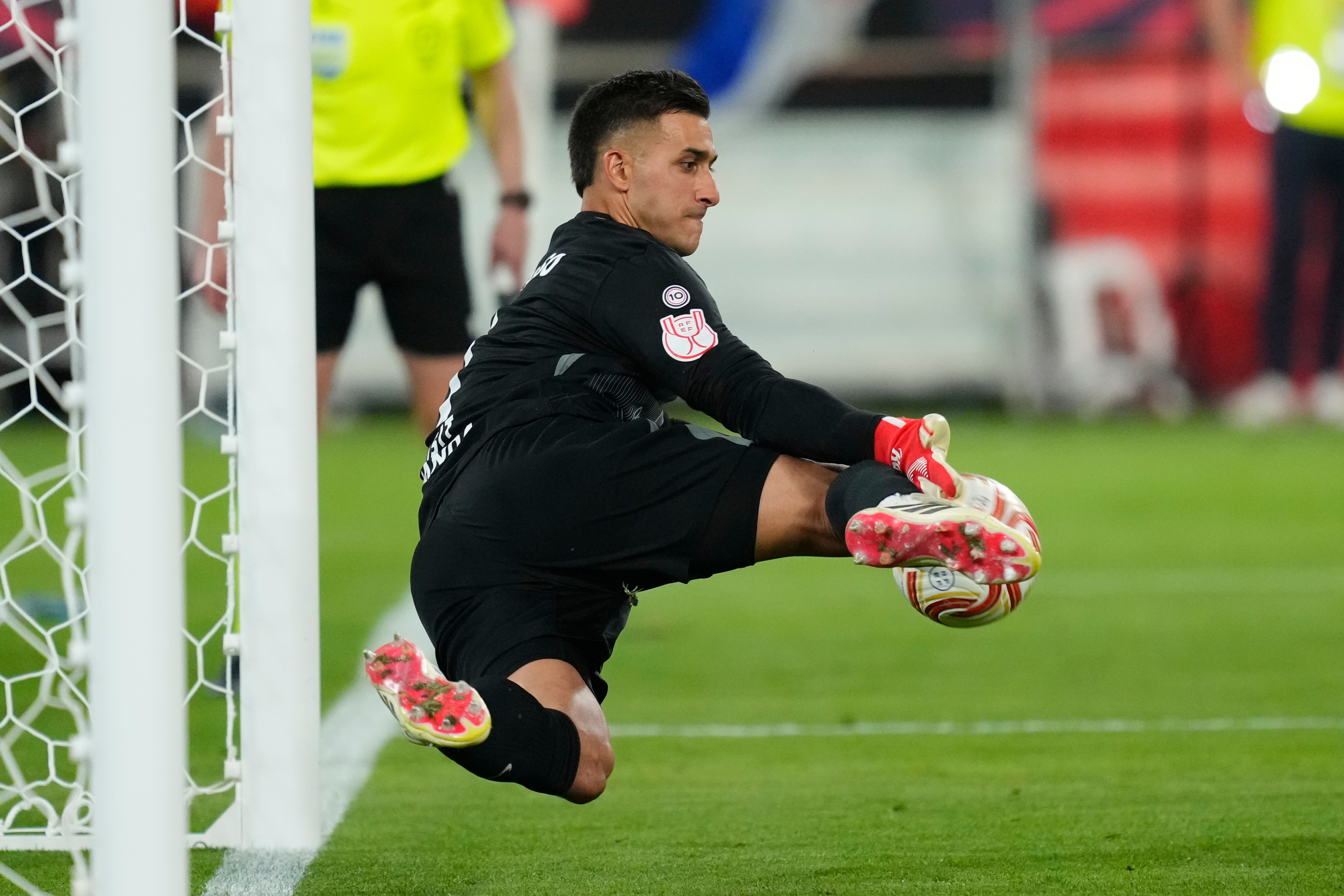 Atletico Madrid's goalkeeper Juan Musso makes a save during during the penalty shoot out at the Copa del Rey final soccer match between Atletico Madrid and Real Sociedad in Seville, Spain, Saturday, April. 18, 2026.