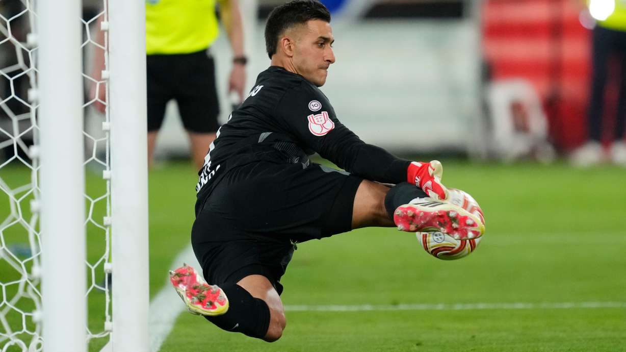 Atletico Madrid's goalkeeper Juan Musso makes a save during during the penalty shoot out at the Copa del Rey final soccer match between Atletico Madrid and Real Sociedad in Seville, Spain, Saturday, April. 18, 2026.