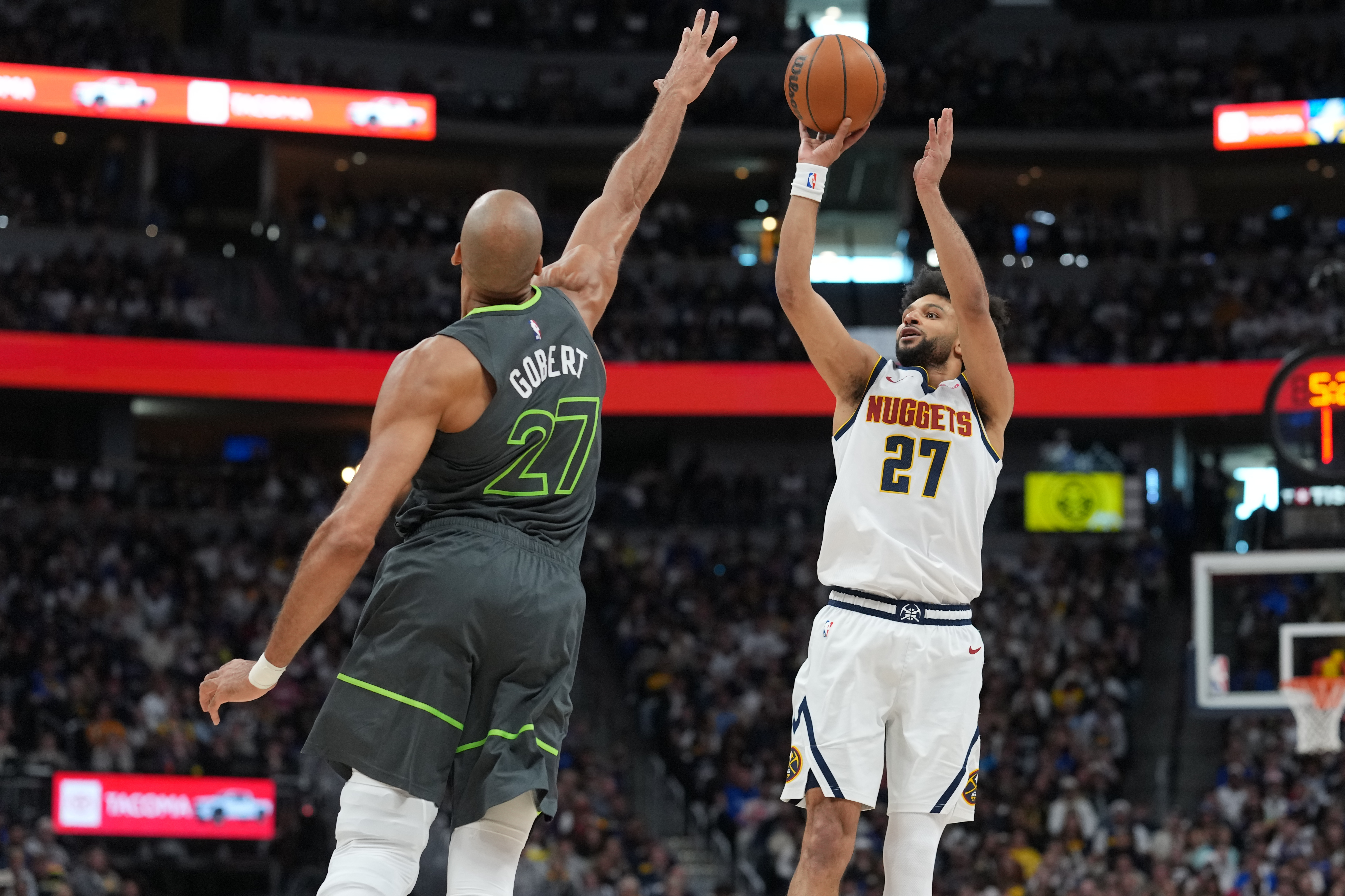 Denver Nuggets guard Jamal Murray, right, shoots over Minnesota Timberwolves center Rudy Gobert in the first half in Game 1 of a first-round NBA playoffs basketball series, Saturday, April 18, 2026, in Denver. 