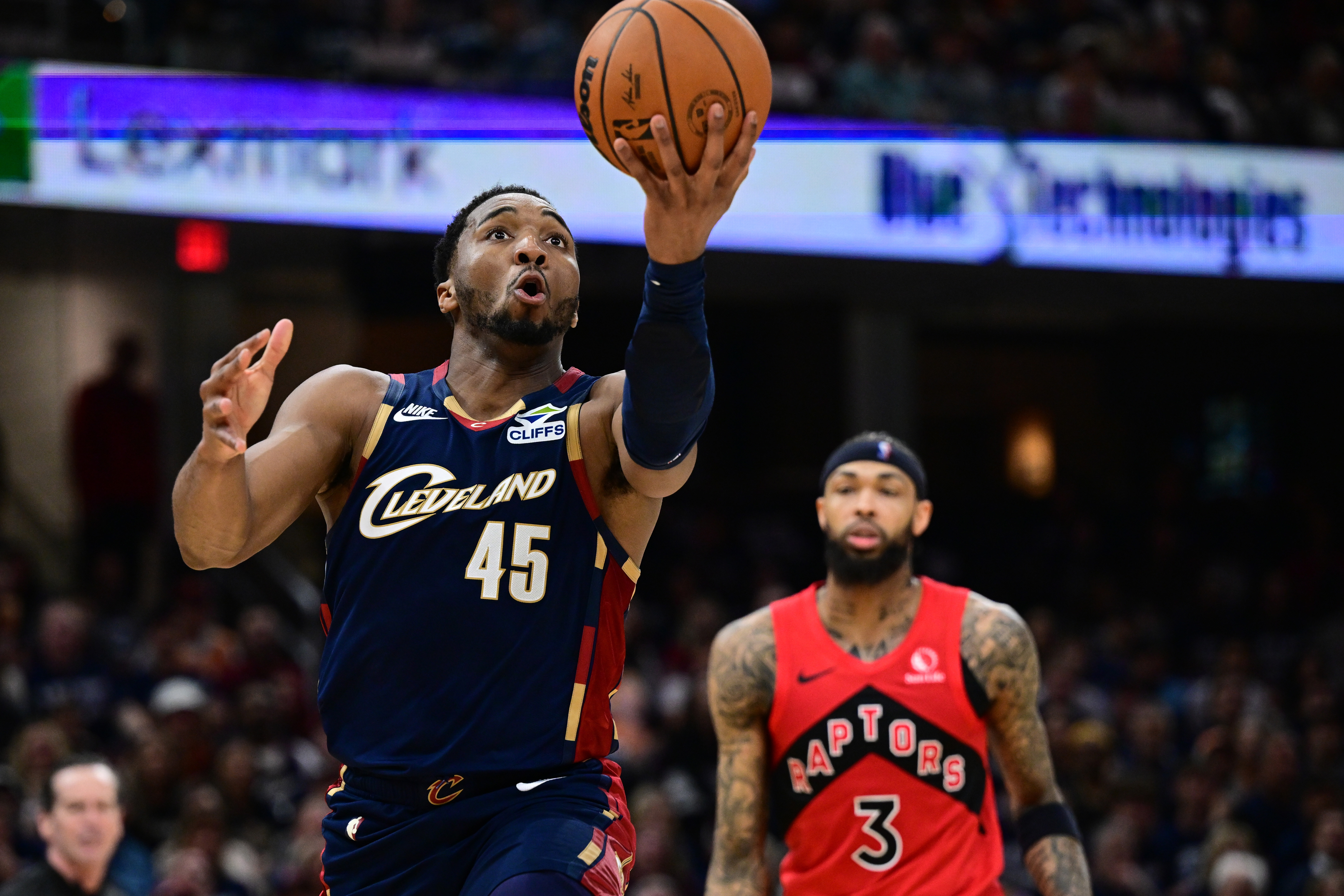 Cleveland Cavaliers guard Donovan Mitchell goes to the basket against the Toronto Raptors during the second half in Game 1 of a first-round NBA playoffs basketball series, Saturday, April 18, 2026, In Cleveland. 