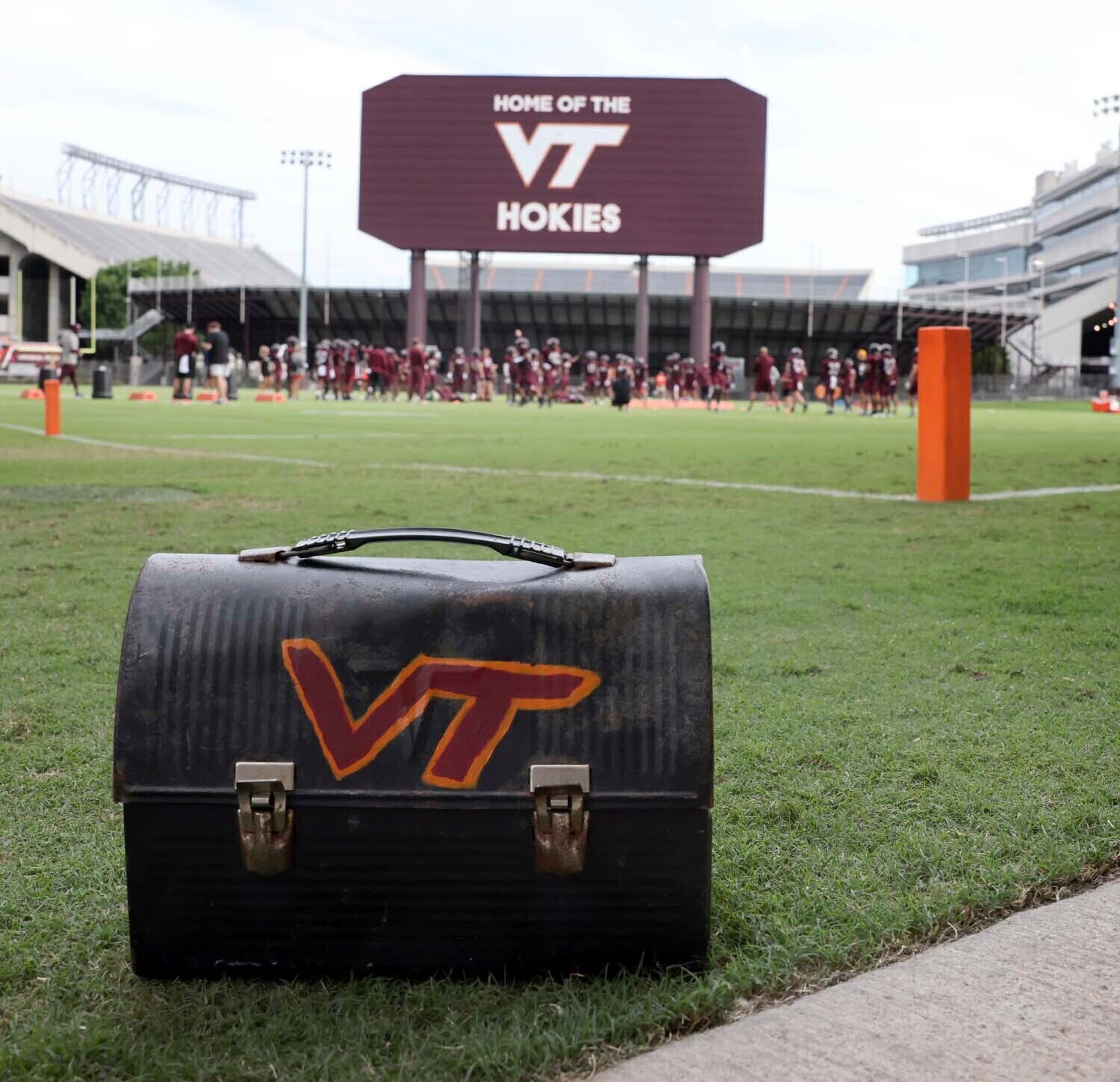 FILE _ The Virginia Tech football team's lunch paile sits on the sideline as the defensive unit practices next to Lane Stadium in Blacksburg, Va. Tuesday Aug. 6 2024. 
