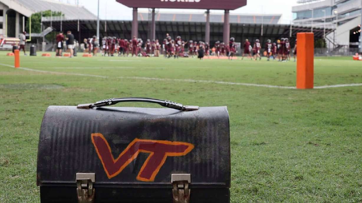 FILE _ The Virginia Tech football team's lunch paile sits on the sideline as the defensive unit practices next to Lane Stadium in Blacksburg, Va. Tuesday Aug. 6 2024.