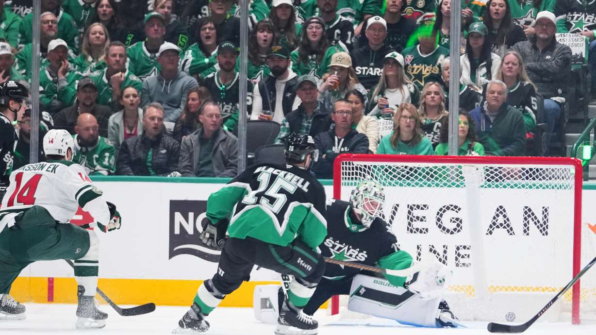 A shot by Minnesota Wild center Joel Eriksson Ek (14) enters the net of Dallas Stars goaltender Jake Oettinger, center, for a goal during the first period in Game 1 of a first-round NHL Stanley Cup playoffs hockey series, Saturday, April 18, 2026, in Dallas, Texas.
