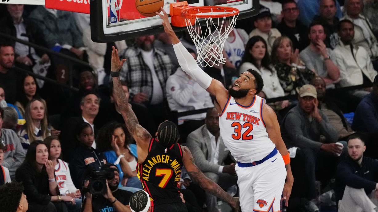 New York Knicks' Karl-Anthony Towns (32) blocks a shot by Atlanta Hawks' Nickeil Alexander-Walker (7) during the first half in Game 1 of a first-round NBA playoffs basketball series, Saturday, April 18, 2026, in New York.