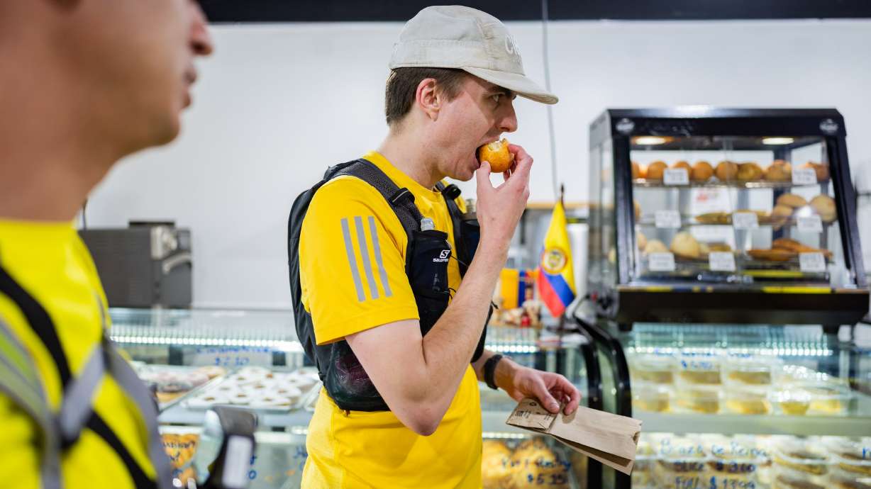 Jacob Sargent eats a pastry at ValSof Bakery while attempting to set a Guinness World Record for fast-food eating in a 24-hour period with seven of his friends in Sandy on April 11.