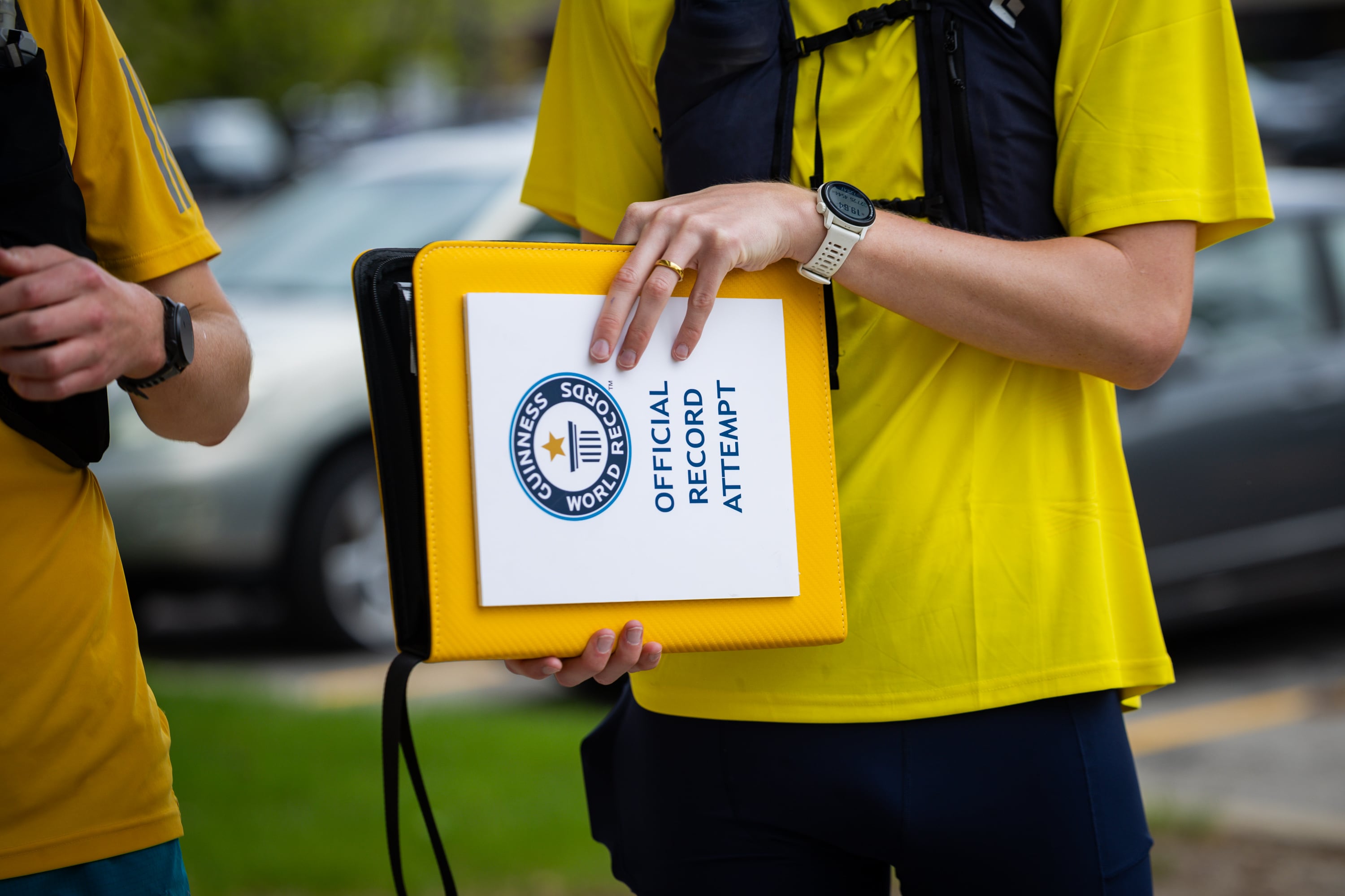 Henry Giles holds a binder full of the group’s receipts as they stand in line at Hot Dog on a Stick while attempting to set a Guinness World Record for fast-food eating in a 24-hour period in Sandy on April 11.