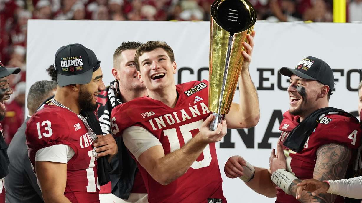 FILE - Indiana quarterback Fernando Mendoza holds the trophy after Indiana defeated Miami in a College Football Playoff national championship game in Miami Gardens, Fla., Jan. 19, 2026,