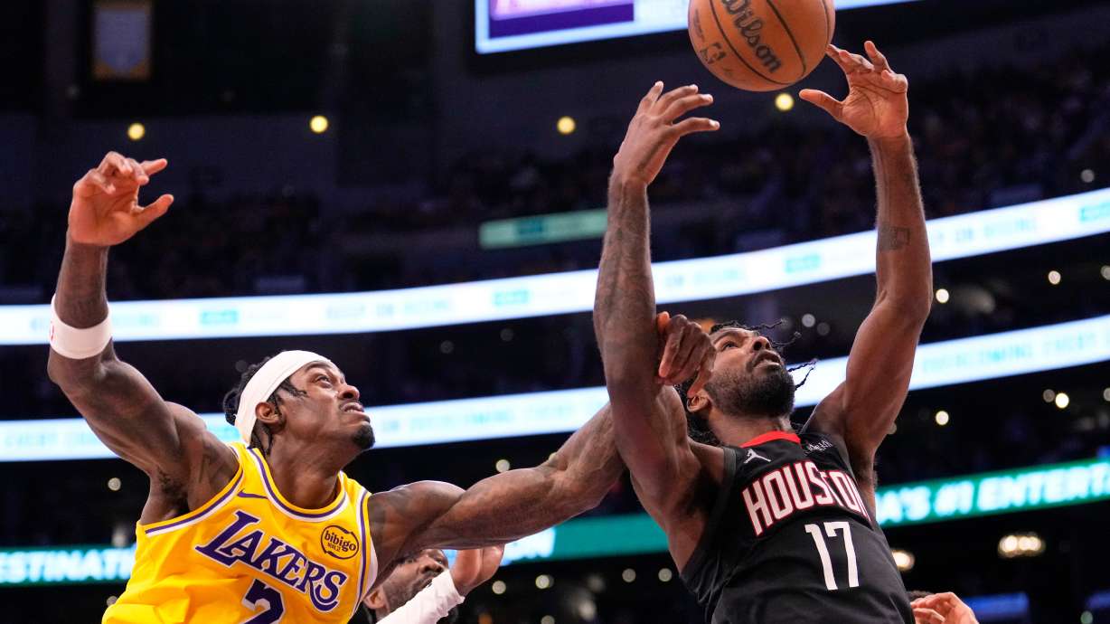 Los Angeles Lakers forward Jarred Vanderbilt, left, and Houston Rockets forward Tari Eason go after a rebound during the second half in Game 1 of a first-round NBA playoffs basketball series Saturday, April 18, 2026, in Los Angeles.