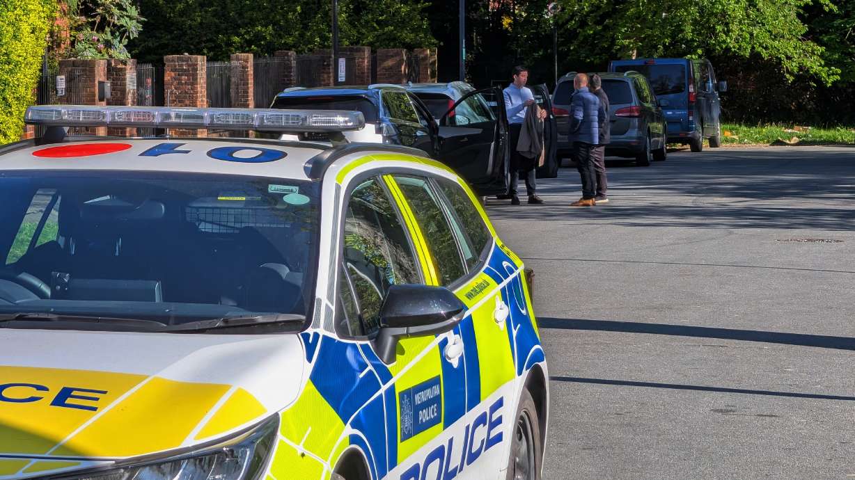 Police officers patrol at a cordon near Kenton United Synagogue in Harrow, a suburb of London, Sunday.
