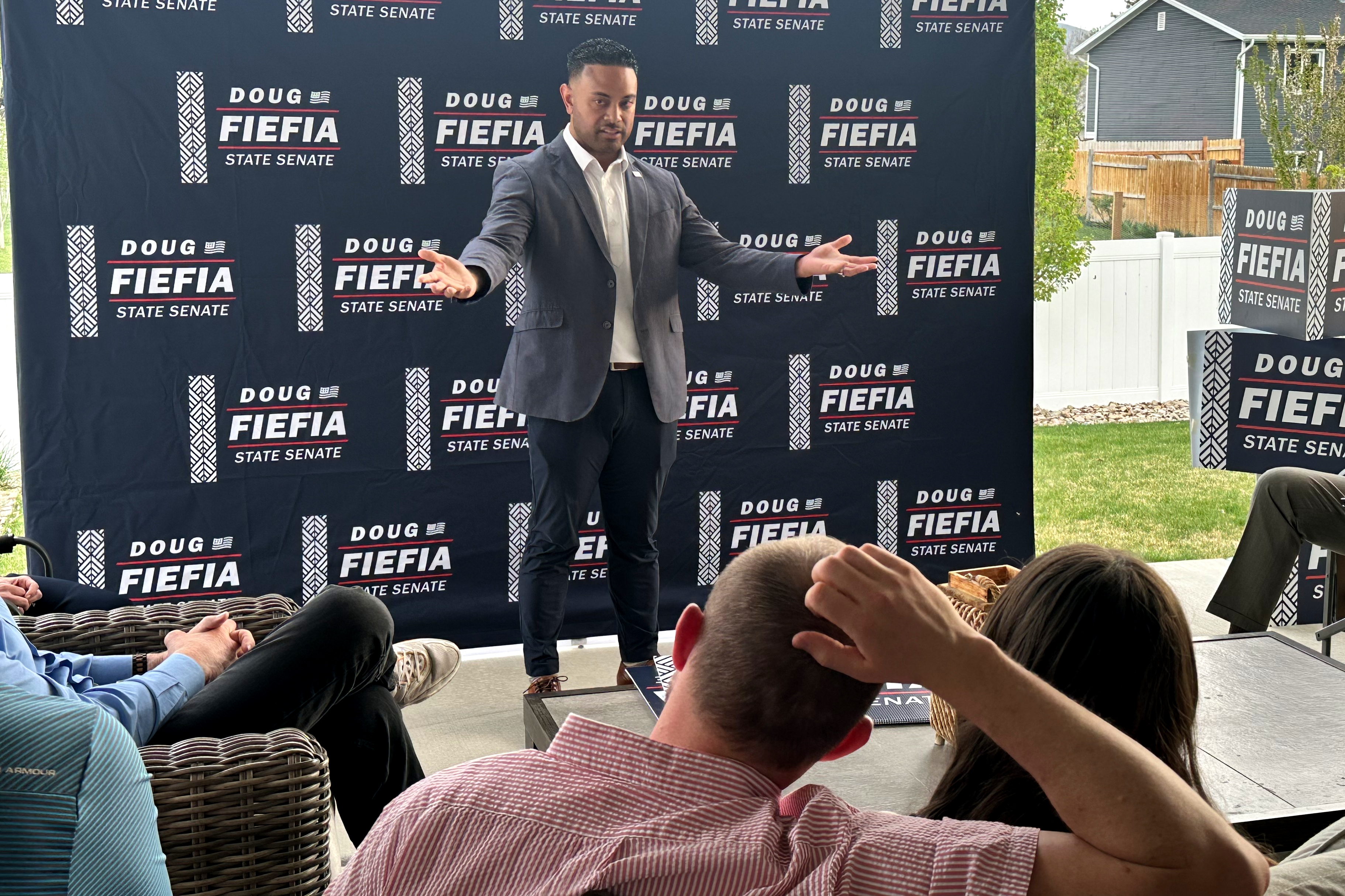 Rep. Doug Fiefia, R-Herriman, talks to voters on the back deck of a house, April 9, in Riverton. Fiefia is challenging Sen. Dan McCay, R-Riverton, for a state Senate seat.